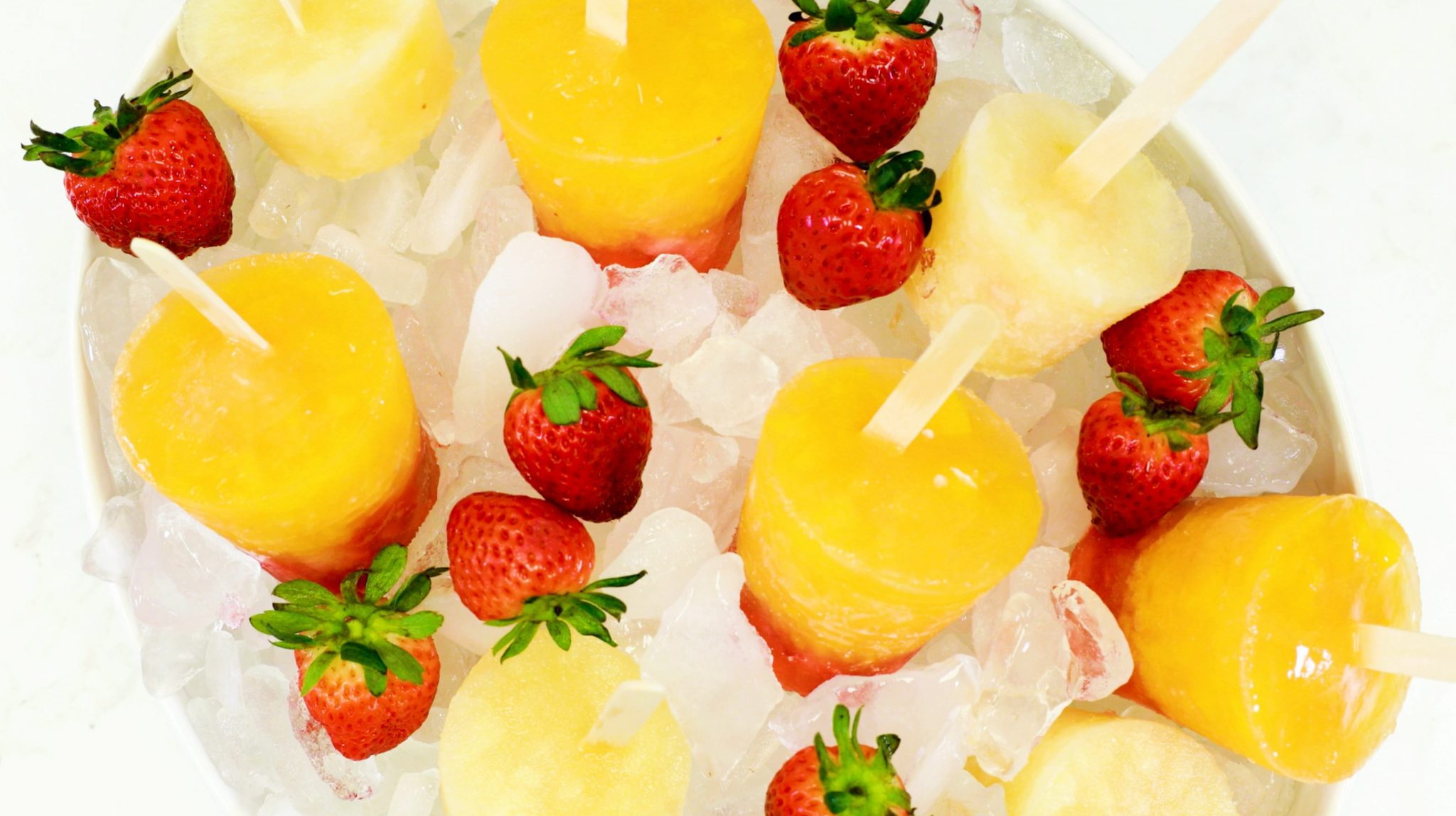 Pear and Sunset Pops, orange pops and strawberries in ice