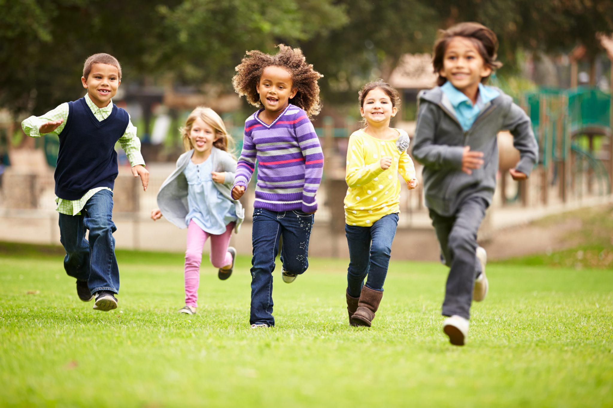 Group of children running in the park.