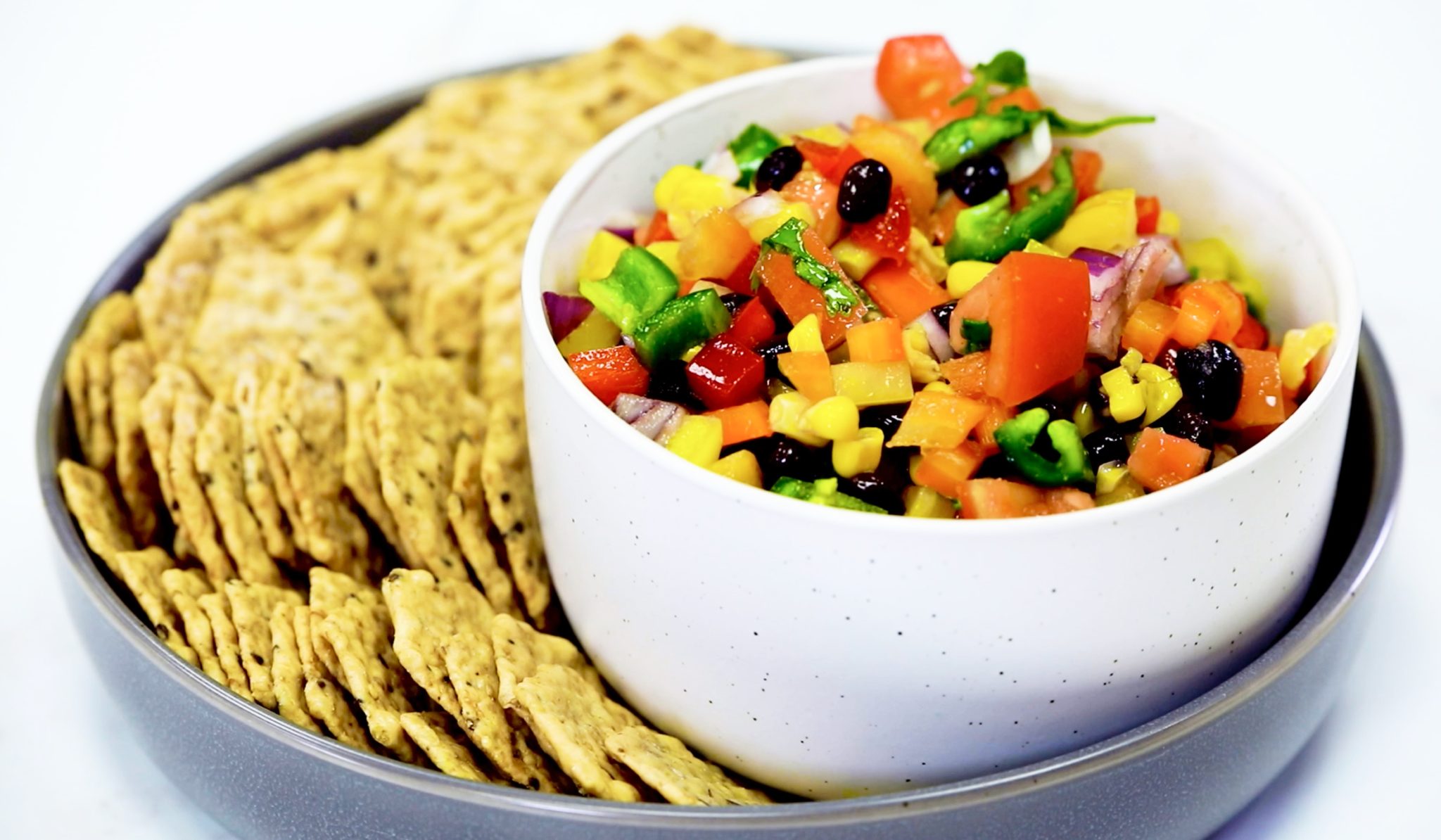 Fiesta Confetti, mixed vegetables in white bowl, crackers