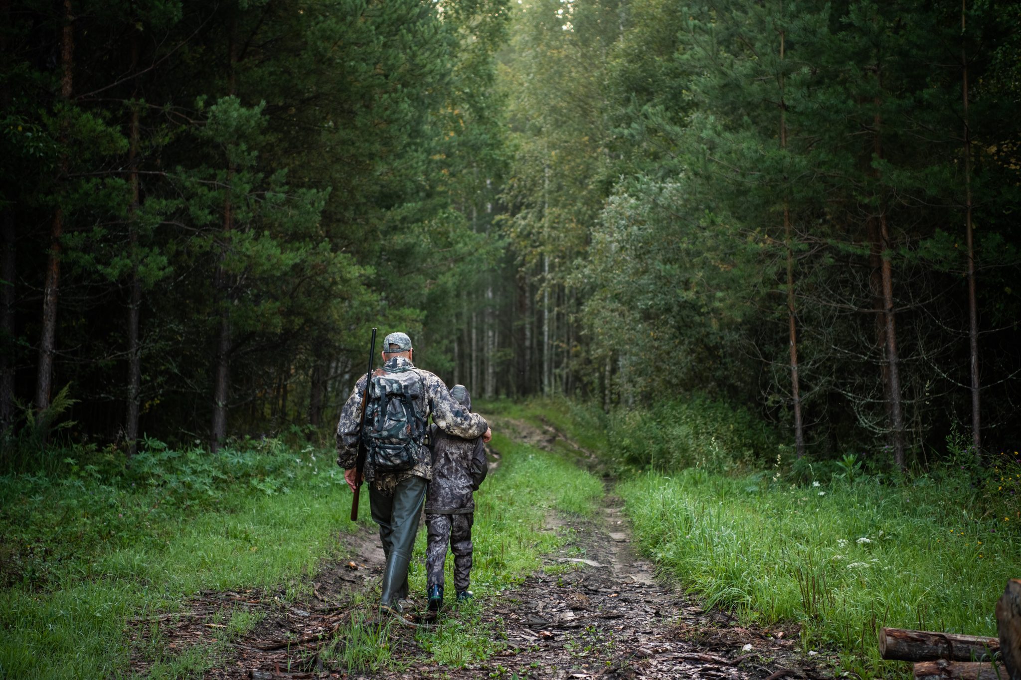 A father and son walking a hunting trail together