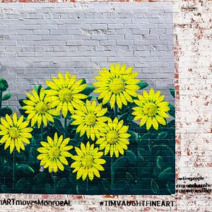 yellow flower mural on brick wall