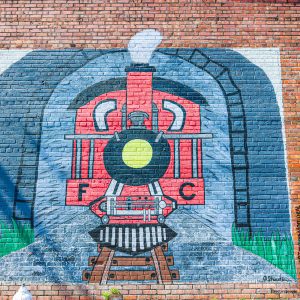 red caboose mural on brick wall