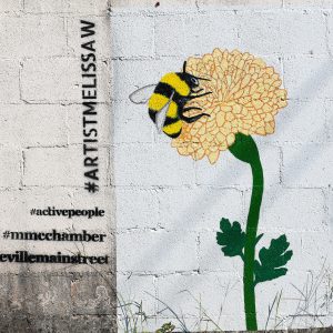 white wall with flower and bee