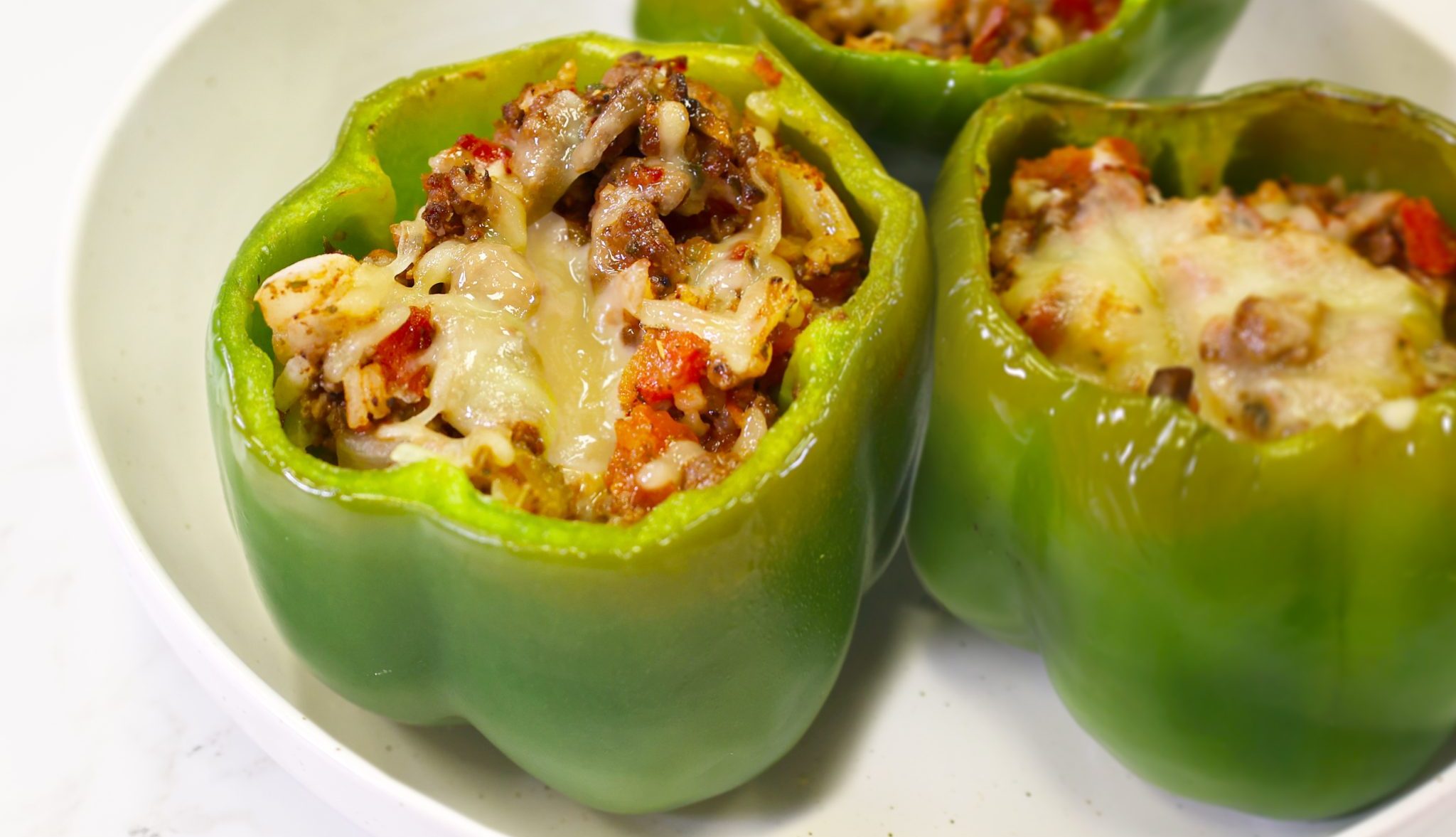 Stuffed Bell Peppers with Ground Venison, venison and cheese in green bell pepper