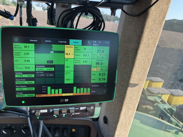 Planter monitor in a tractor cab. Farmer using precision ag technologies