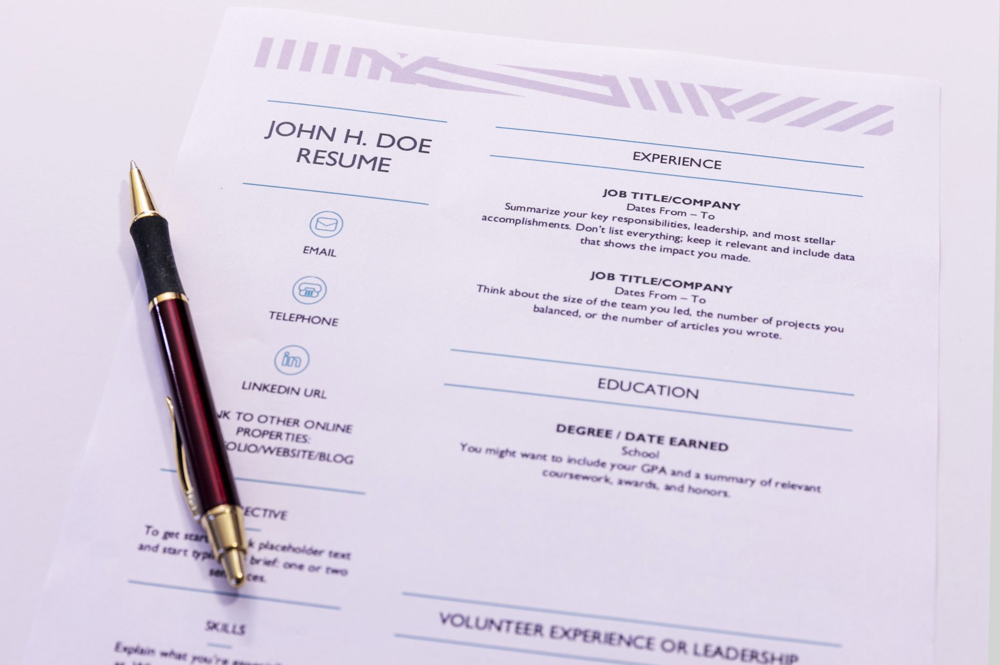 a resumé for John H. Doe on a desk with a pen
