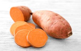 A sliced sweet potato on a white table and background