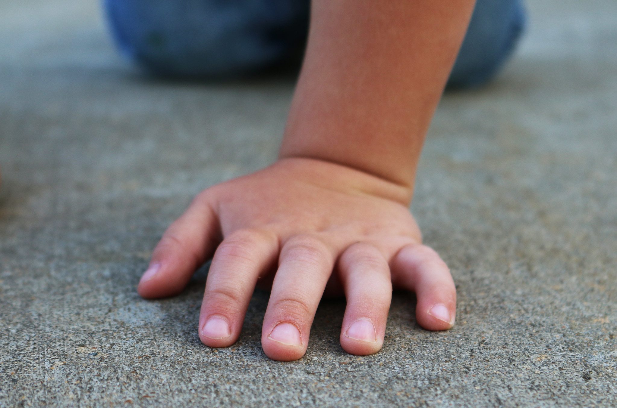 a child's hand on the concrete. child abuse prevention resources