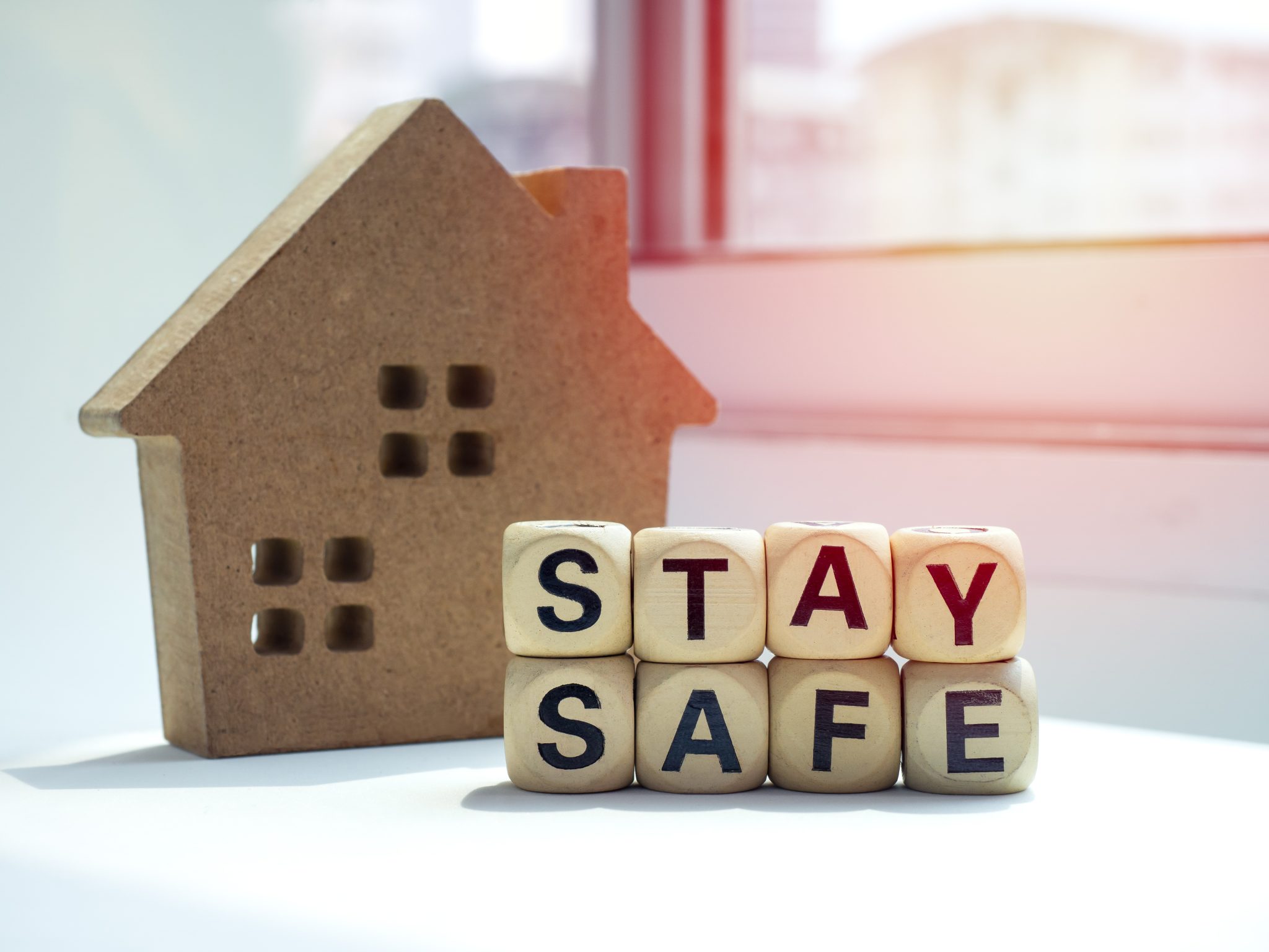 Wooden block house with wooden blocks that say Stay Safe.