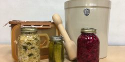 Tools used in fermentation with jars of fermented vegetables.