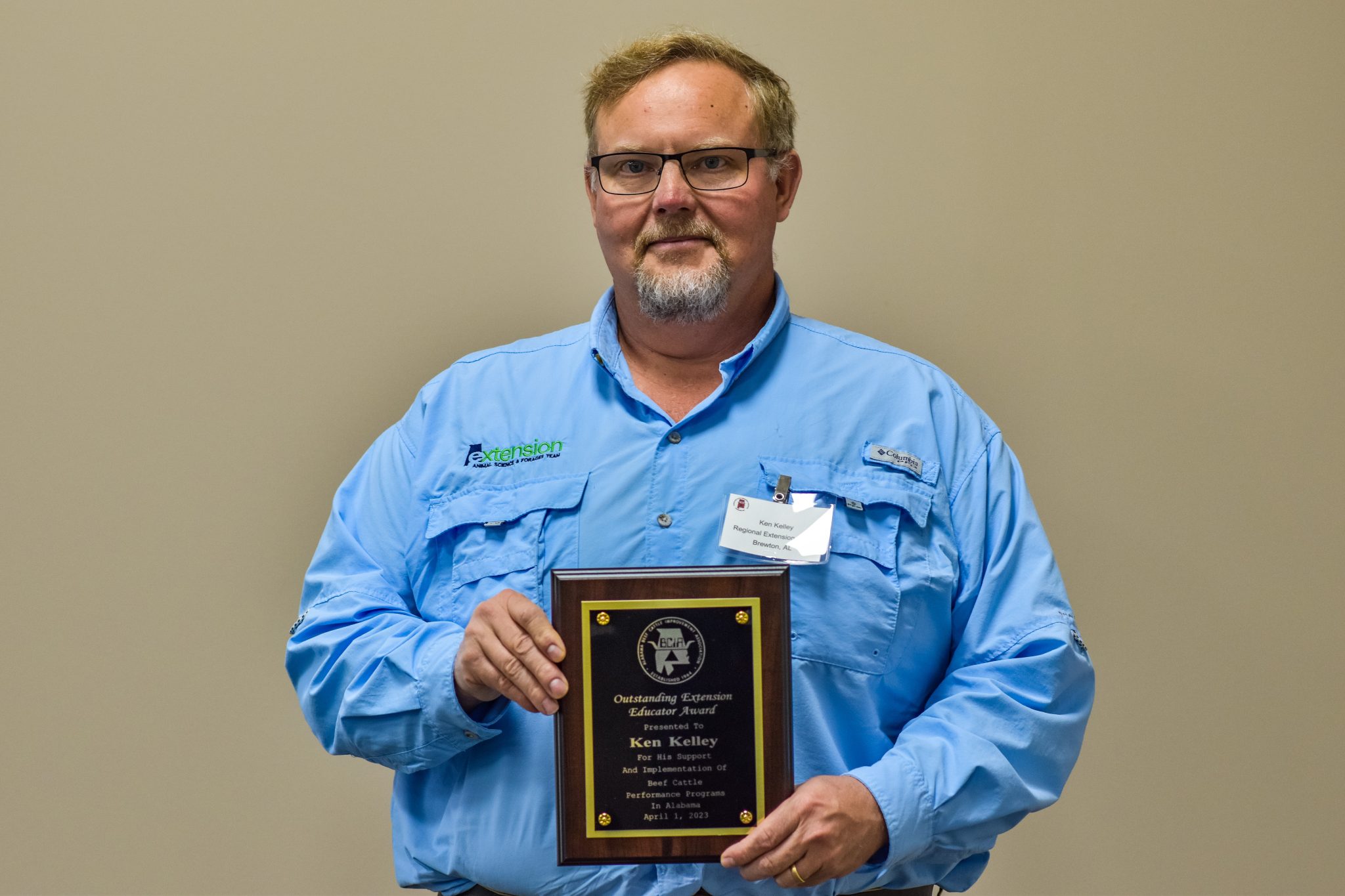 Ken Kelley poses with his plaque designating him as the Alabama Beef Cattle Improvement Association's 2022 Outstanding Extension Educator of the year.