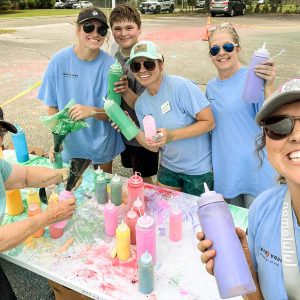 A group of adults volunteering at the Color Run at Abbeville Elementary