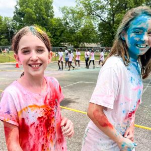 Two children running at the Color Run at Abbeville Elementary