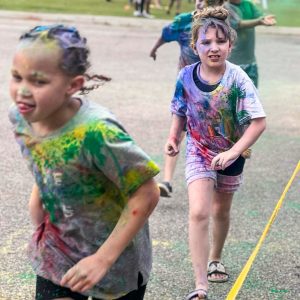 Two children running at the Color Run at Abbeville