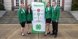 Alabama 4-H Ambassadors posing in front of Duncan Hall on Auburn's campus.