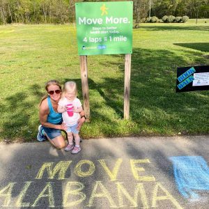 Woman with young girl, Move Alabama, Move More Green Sign