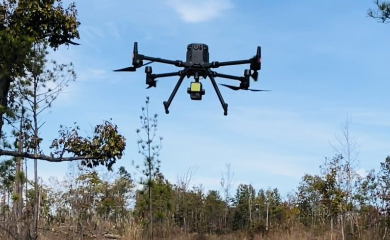 A drone flying over forestland.