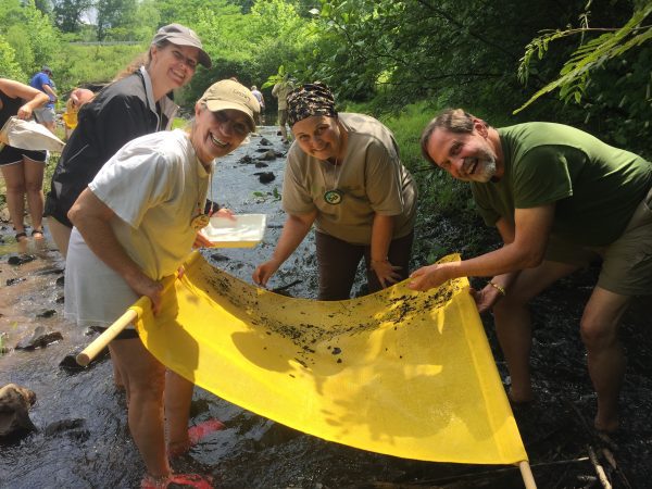 Alabama Water Watch volunteers pose while conducting a stream bioassessment.