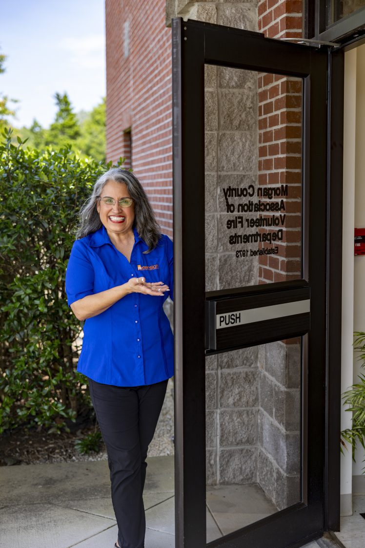 Norma Gardner opening the door to the Morgan County Extension office.