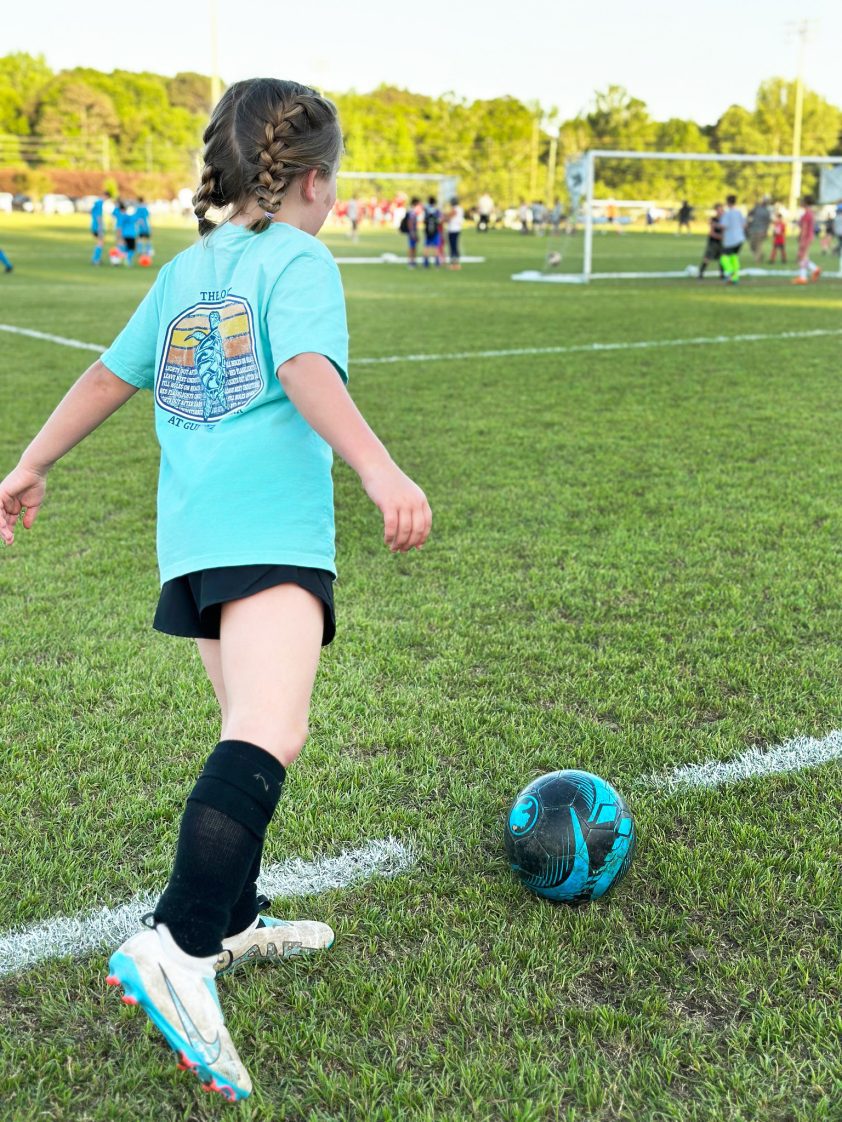 A young girl playing soccer