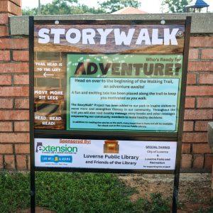 Metal sign advertising a story walk