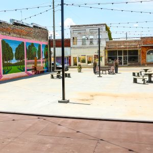 A picture of the new concrete patio, benches, and mural at the renovated terrace in Linden, Alabama.