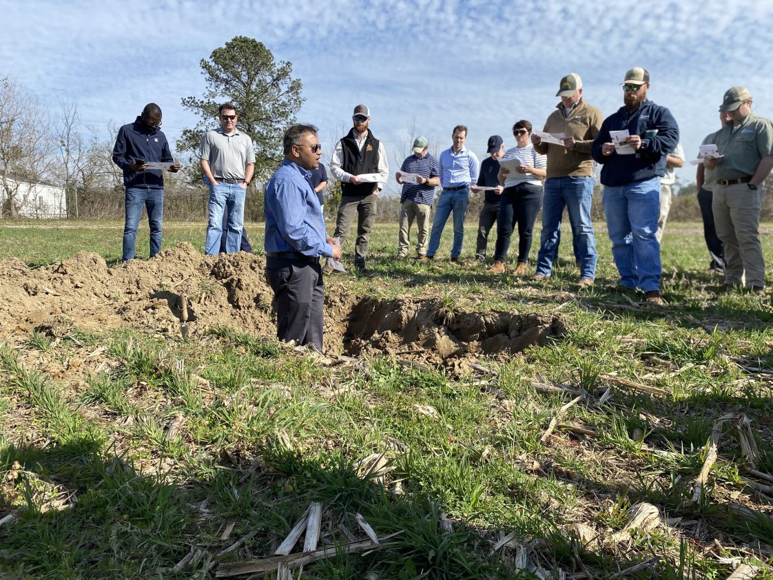 Figure 11. Rishi Prasad speaks to Alabama row crop growers at a field day presentation.