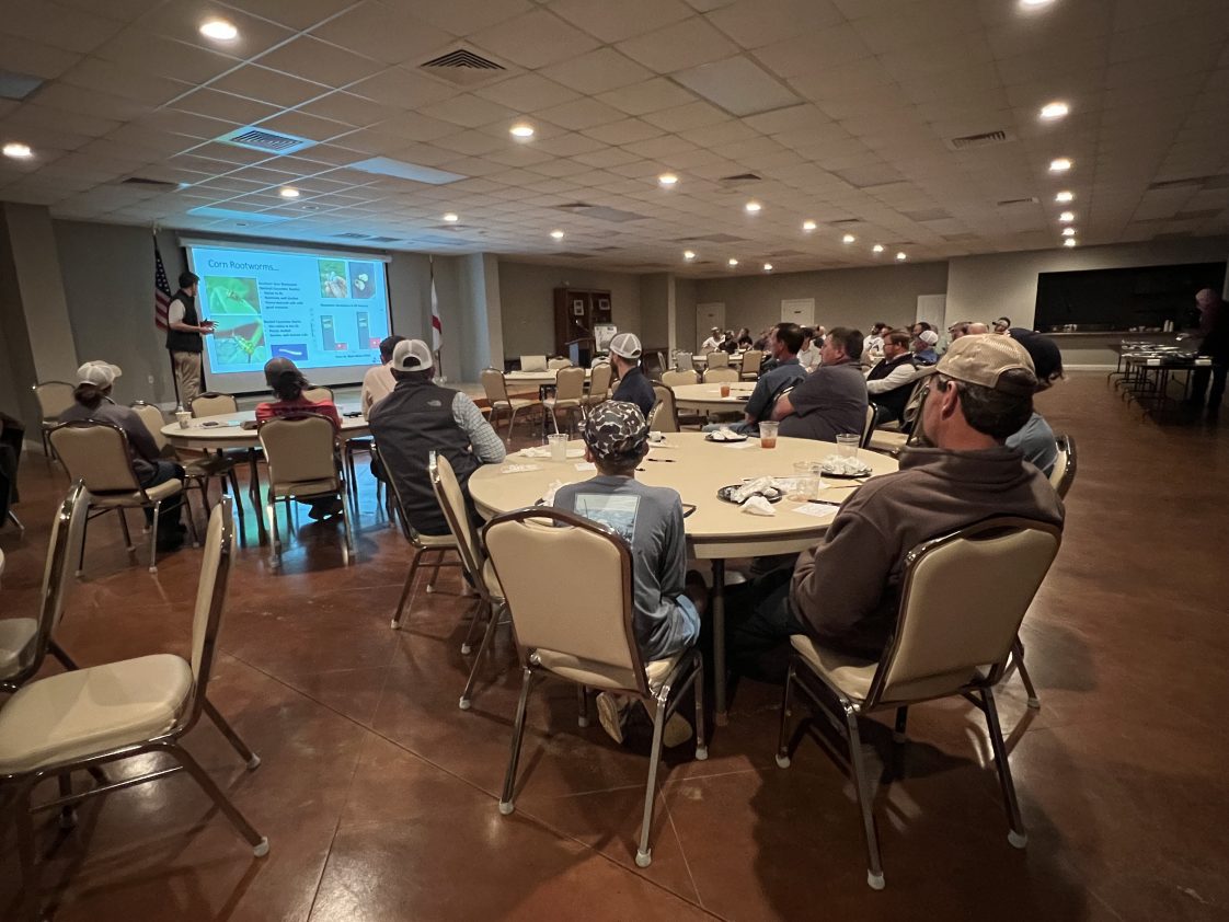 Figure 1 . Scott Graham and Caitlyn Lawton present insect control updates to local row crop growers at an Alabama Extension event.
