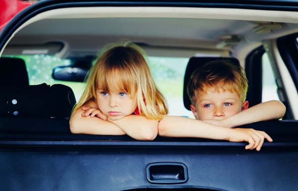 little girl and boy waiting in car bored sad tired
