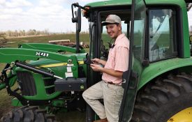 Garrett Dixon poses on a tractor
