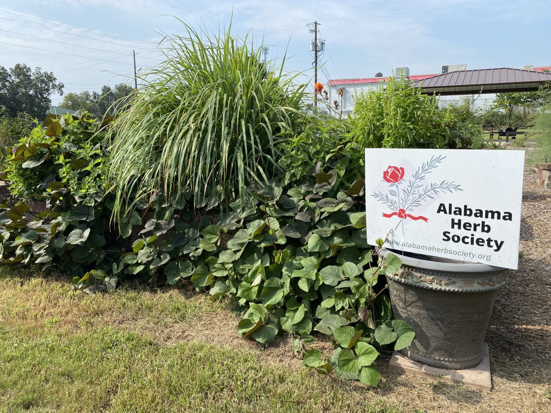The Crump Community Center garden with an Alabama Herb Society yard sign.