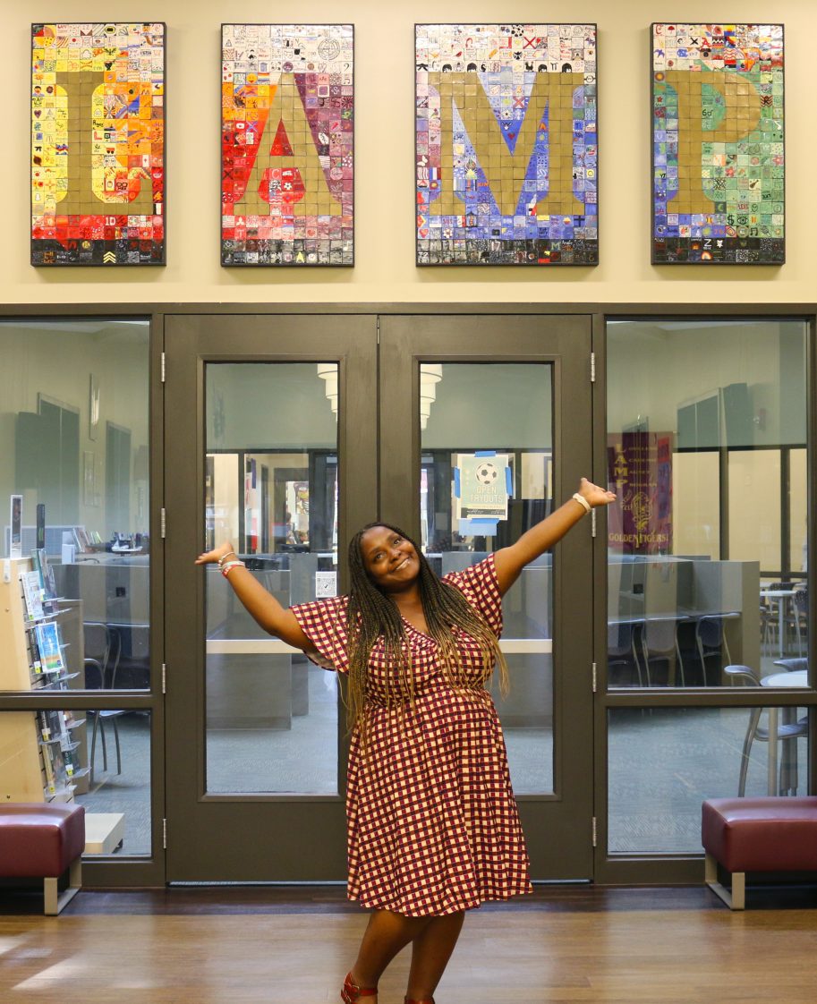 Kwan Robinson in front of the LAMP High School library