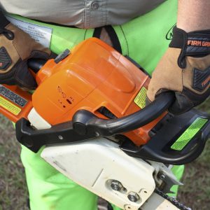 Figure 18. Always use two hands on the saw. Wrap thumbs around handles and engage the chain brake if removing a hand or taking more than two steps.