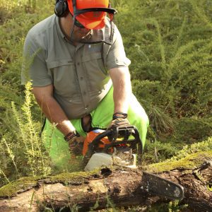 Figure 22. Do not bend over when cutting wood on the ground; instead, take a knee. This reduces back fatigue and provides more control.