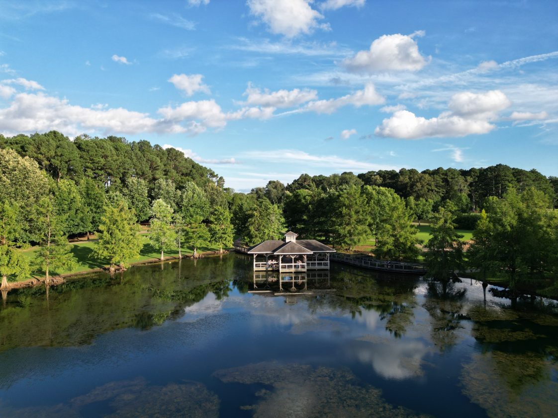 An aerial view of a lake in a forested landscape in Florence, Alabama