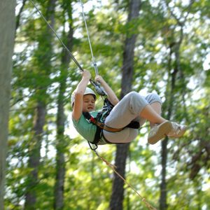 A 4-H member on a zip-line.