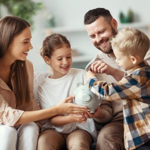 Financial planning family mother father and children with piggy Bank at home