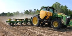 tractor planting corn into strip-tilled ground