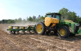 tractor planting corn into strip-tilled ground