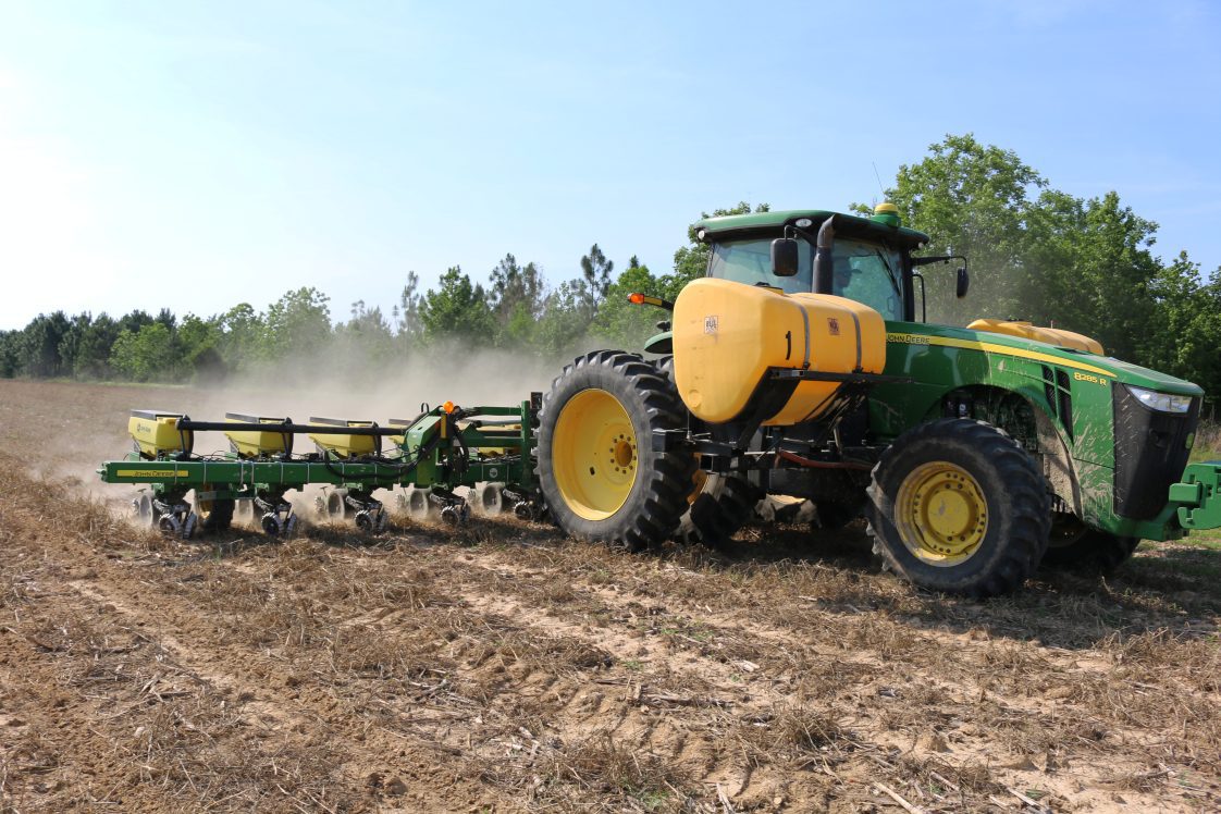 tractor planting corn into strip-tilled ground