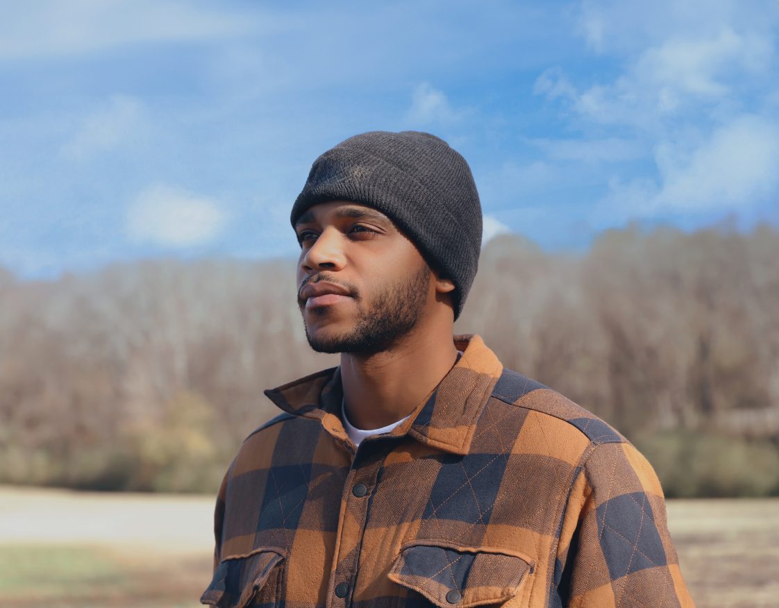 Daivon Allen pictured with a blue sky and trees background.