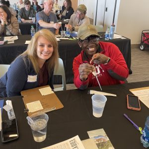 Participants learn to pipette water during an AWW bacteriological monitoring training.