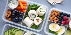 Healthy lunch or snack to go with tortilla wraps, eggs, cottage cheese, fruits, and vegetables.