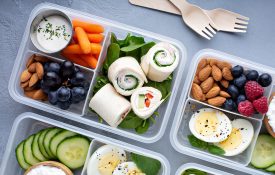 Healthy lunch or snack to go with tortilla wraps, eggs, cottage cheese, fruits, and vegetables.