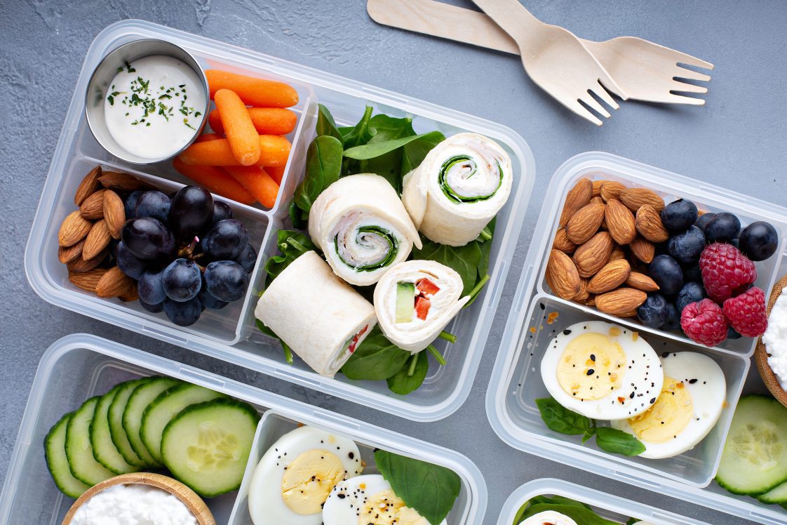 Healthy lunch or snack to go with tortilla wraps, eggs, cottage cheese, fruits, and vegetables.