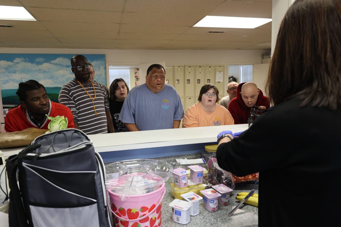 Participants watching Sherri Mulder make fruit parfaits at a party at the RCLC.