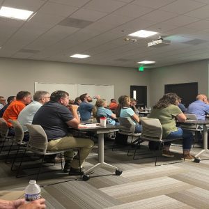 A group of people sitting in a conference room during the Pullet and Broiler Breeder Conference.