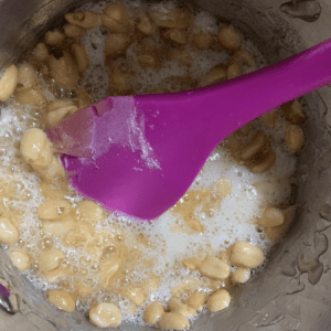 Peanut brittle being cooked in a pot.