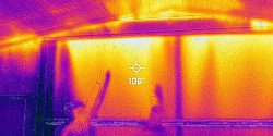 Figure 3. Can you identify the problem or problems in this thermal image of an end wall door? A. Top of door leaking hot air, B. No insulation in ceiling, C. Air leaking between ceiling and end wall, D. Hot air leaking through these openings would lower full tunnel wind speed and lead to additional heat gain from missing insulation, E. All the above. If you answered E (All the above), you would be correct. Once again, this house is not ready for hot weather and might not pass a house tightness test or wind speed test.