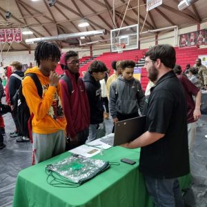 4-H Tech Changemakers speaking to other student at a booth.